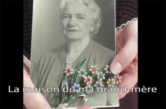 A beautiful flowery brooch holds a portrait of an elderly woman.